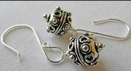 Ornate silver-tone drop earrings with spiral details